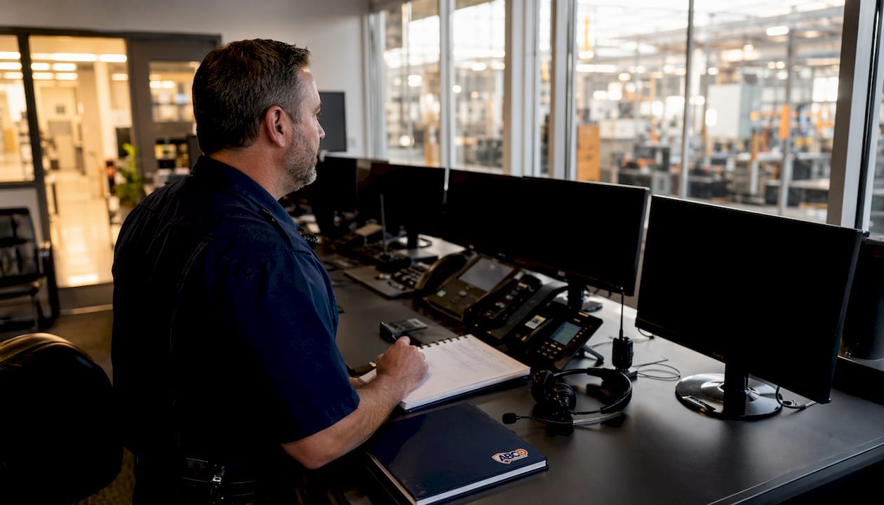 Facility manager monitoring industrial security system