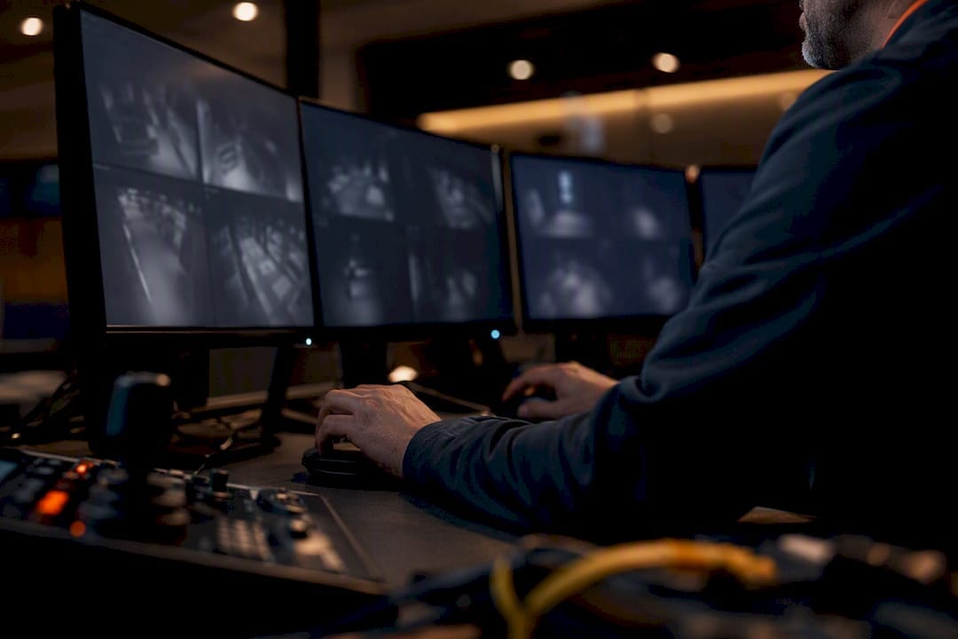 Technician adjusting remote video monitoring equipment