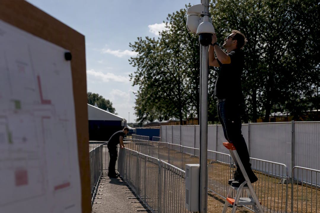 Security team setting up festival entrance barriers