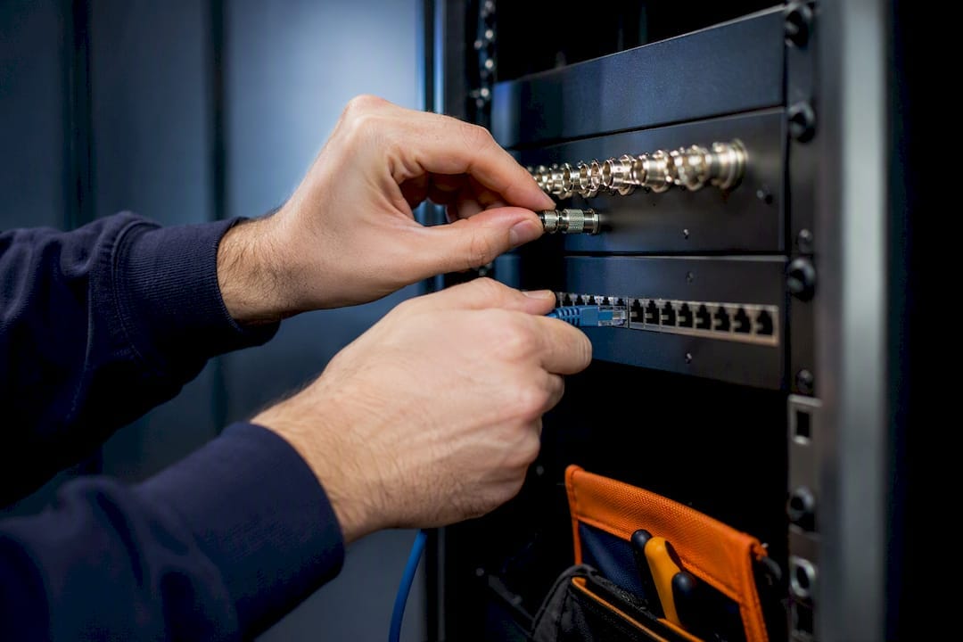 NVR or DVR? Five on site checks for site managers 9 Technician connecting analogue and IP feeds