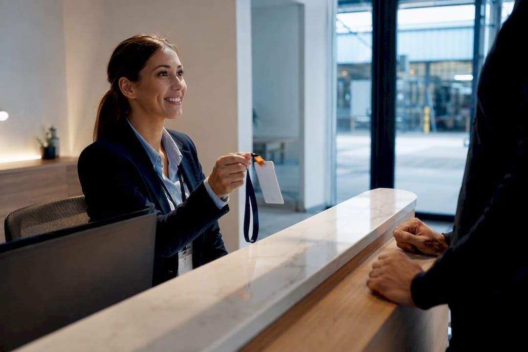 4 Audit Ready Checks for Visitor Management Policy, Security Managers 8 Reception coordinator verifying visitor induction badge