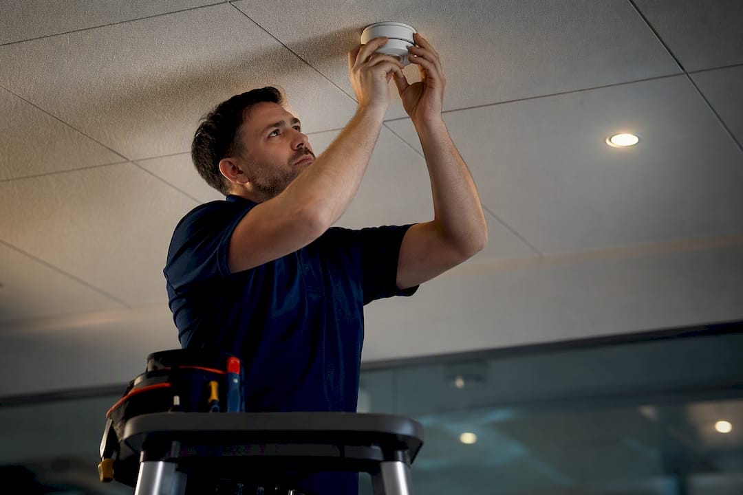 Cut false alarms this week: Building owners check 12 months' history 8 Technician adjusting a ceiling alarm detector